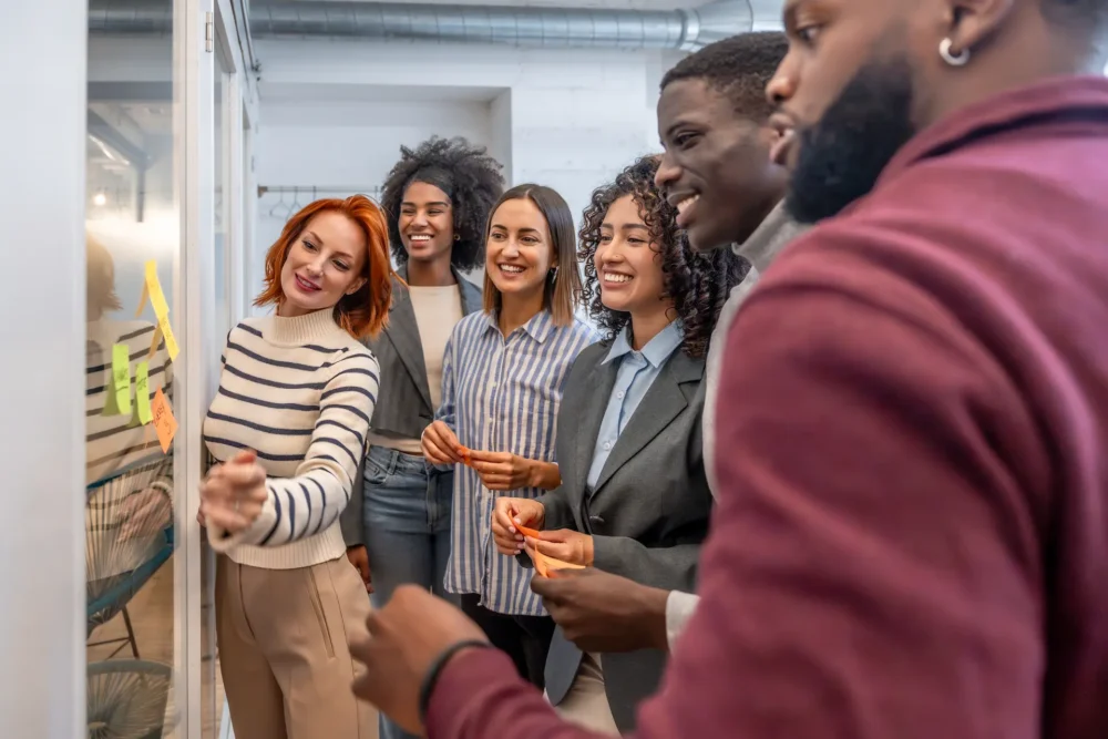 Side view of diverse males and females coworkers during a brainstorming creative process in the office